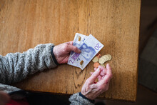 Hands Holding Banknotes And Coins, Sweden