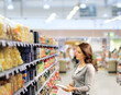 © lado2016 - Woman choosing a dairy products at supermarket