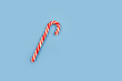 © Анастасия Бурлакова - Mint hard candy cane striped in Christmas colours on blue background. Closeup.
