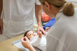 © Johnér - Female doctor examining baby, Sweden