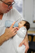 © Johnér - Doctor feeding newborn baby, Sweden