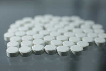 Wall Mural - White pills on glass table