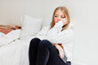 © Johnér - Worried woman sitting in bedroom, Sweden