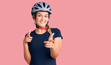 Beautiful Caucasian Woman Wearing Bike Helmet Pointing Fingers To Camera With Happy And Funny Face. Good Energy And Vibes.