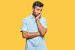 © Krakenimages.com - Handsome hispanic man wearing casual clothes thinking looking tired and bored with depression problems with crossed arms.