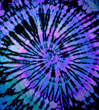 Spiral tie dye texture. Hippie tie-dye wallpaper. Boho festival tiedye background in purple.