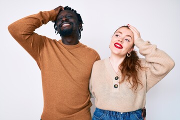 Poster - Interracial couple wearing casual clothes smiling confident touching hair with hand up gesture, posing attractive and fashionable