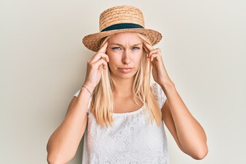 Sticker - Young blonde girl wearing summer hat with hand on head, headache because stress. suffering migraine.