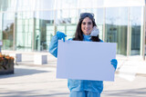 Fototapeta  - Female doctor against COVID19, with a blank sign
