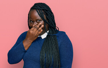 Poster - Young black woman with braids wearing casual clothes smelling something stinky and disgusting, intolerable smell, holding breath with fingers on nose. bad smell