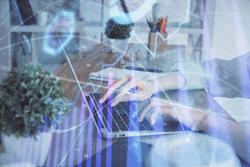 Double exposure of woman hands typing on computer and forex chart hologram drawing. Stock market invest concept.