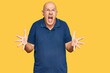 © Krakenimages.com - Middle age bald man wearing casual clothes crazy and mad shouting and yelling with aggressive expression and arms raised. frustration concept.