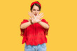© Krakenimages.com - Young brunette woman with short hair wearing casual summer clothes and diadem rejection expression crossing arms doing negative sign, angry face