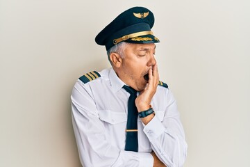 Poster - Handsome middle age mature man wearing airplane pilot uniform bored yawning tired covering mouth with hand. restless and sleepiness.