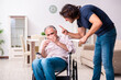 © Elnur - Old man in wheel-chair and young bad caregiver indoors