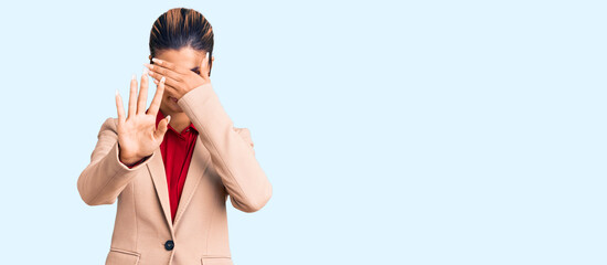 Poster - Young beautiful woman wearing business shirt and glasses covering eyes with hands and doing stop gesture with sad and fear expression. embarrassed and negative concept.