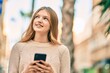 © Krakenimages.com - Beautiful caucasian teenager smiling happy using smartphone at the city.