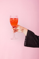 Young woman hand holding glass with cocktail.