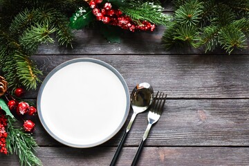 christmas table setting with christmas decorations.Christmas dinner plate decoration with Christmas ornaments on wood background. Merry christmas greeting card. Winter holiday theme. Happy New Year.