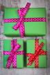 Wrapped green gifts for Christmas or other celebration on old white plank