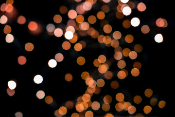 Wall Mural - Blurred abstract gold glitter texture, defocused christmas lights on black background. Holiday christmas concept.