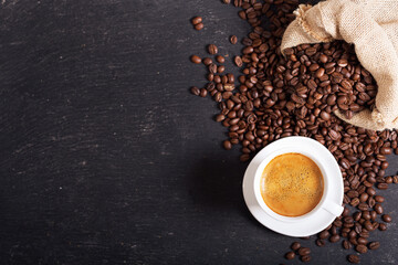 Wall Mural - cup of coffee and coffee beans on dark background