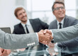 © ASDF - handshake of business people on a blurred office background.
