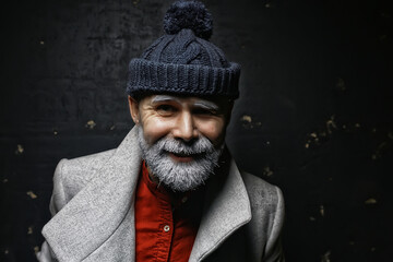 brutal man with a beard in winter clothes / portrait person with a gray beard, hipster warm clothes winter