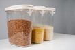 Various groats in plastic conctainers. Food storage, recipe, nutrition concept. Close-up, copy space.