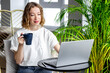 © 9dreamstudio - Business meeting online - young woman working on laptop at home