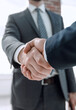 © ASDF - business leader shaking hands with partner.
