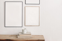 Set Of Black Portrait Picture Frame Mockups. Wall Art Gallery. Cup Of Coffee On Pile Of Books On Old Wooden Bench, Table. White Wall Background. Scandinavian Interior, Neutral Color Palette.