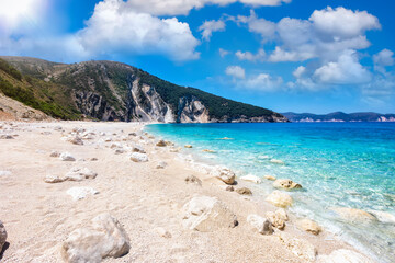 The beautiful beach of Myrtos on the Ionian island of Kefalonia, Greece, with soft tones pebbles and rocks and turquoise sea, without people