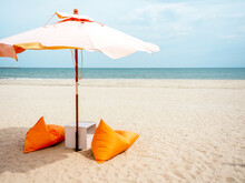Orange Beach Umbrellas And Bean Bag Chairs On The Beach.