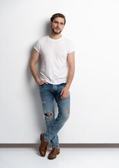 Full length studio portrait of casual young man in jeans and shirt. Isolated on white background.