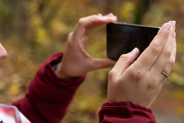 Sticker - Female hands holding phone outdoor