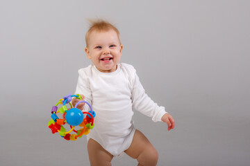 baby playing with a colorful toy isolated on a white background