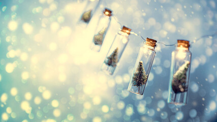 Wall Mural - close-up, elegant christmas tree in glass jar with bokeh lights background, copy space. christmas an