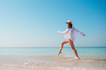 young fashion woman in green dress on the beach