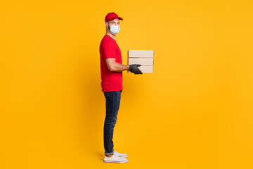 Sticker - Profile photo of courier man hold parcel boxes wear gloves mask red t-shirt cap jeans sneakers isolated yellow color background