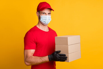 Wall Mural - Photo of delivery guy hold pile paper boxes look camera wear mask red t-shirt cap isolated yellow color background