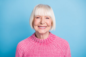 Poster - Photo portrait of smiling elderly woman isolated on pastel blue colored background