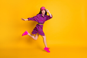 Poster - Full body profile portrait of adorable person running arm touching headwear isolated on yellow color background