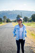 © Clare Seibel-Barnes/Austockphoto - Middle aged woman walking down a rural road for exercise