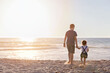 © Michelle Jones/Austockphoto - Boy And Little Girl Walking Towards The Ocean At Sunset