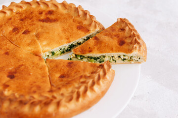 Pie with egg and onion on a plate, Russian pastries