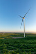© Rosalie Dibben/Austockphoto - wind tower with wind farm in distance - vertical