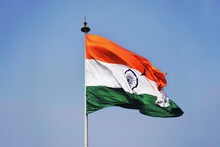 Low Angle View Of Indian Flag Waving Against Clear Blue Sky