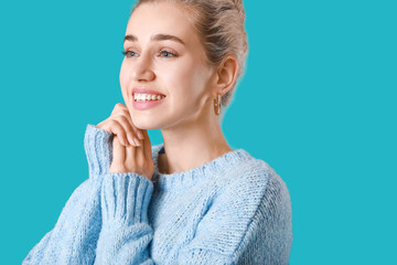 Sticker - Beautiful young woman in warm sweater on color background