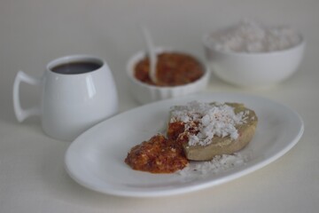 Wall Mural - Steamed yam served with freshly grated coconut and red chilly chutney. 